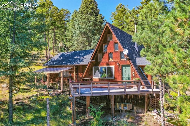 rear view of property with a wooden deck