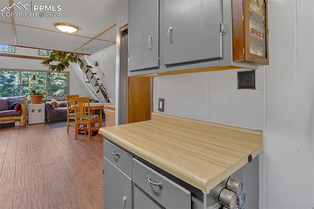 kitchen featuring hardwood / wood-style floors and gray cabinetry