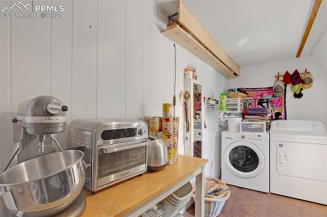 laundry area with wood-type flooring and washer and clothes dryer