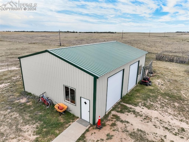 view of outbuilding featuring a garage and a rural view