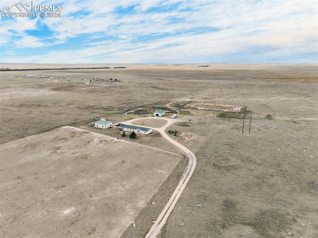 birds eye view of property with a rural view