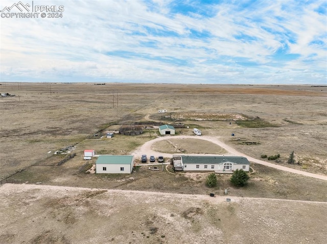 birds eye view of property with a rural view