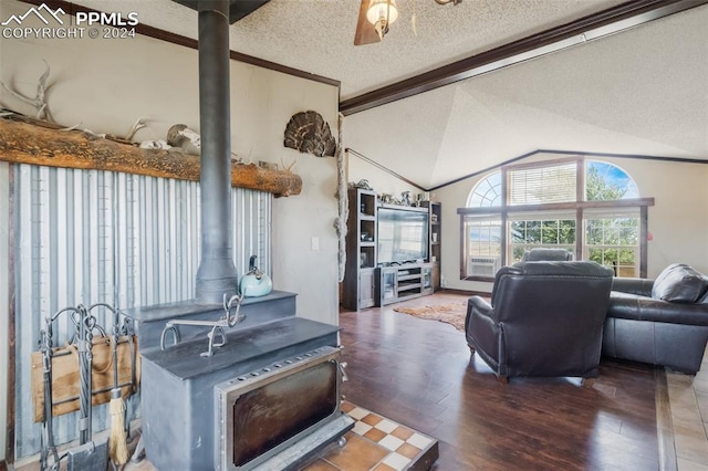 living room with a textured ceiling, vaulted ceiling, dark wood-type flooring, and a wood stove