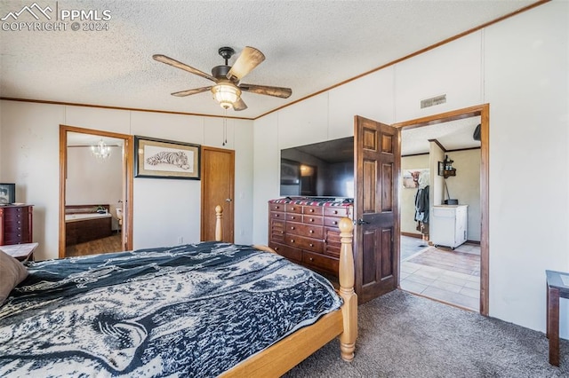 bedroom featuring a textured ceiling, carpet flooring, vaulted ceiling, crown molding, and ceiling fan