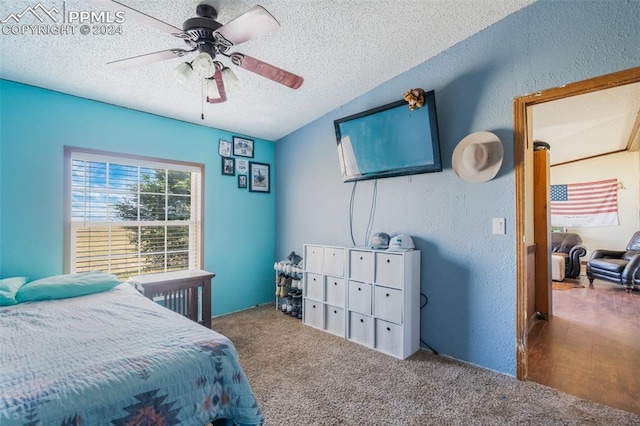 carpeted bedroom featuring vaulted ceiling, ceiling fan, and a textured ceiling