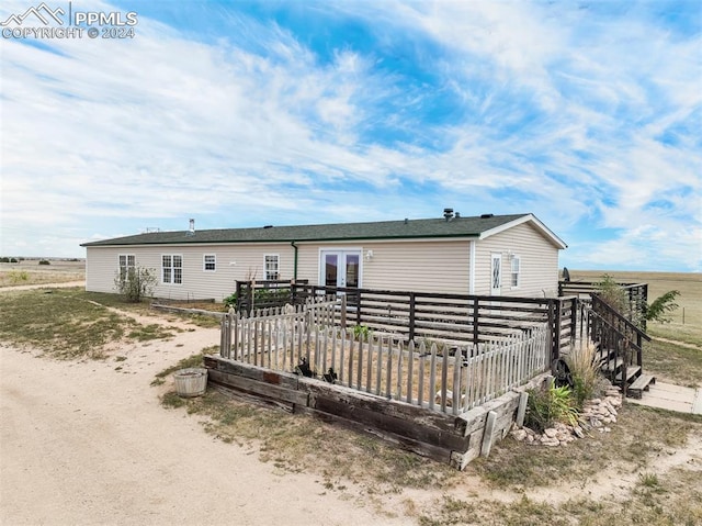 back of property featuring a rural view