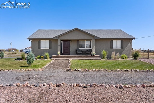 ranch-style home with a front lawn