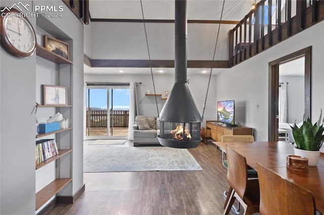 living room with hardwood / wood-style floors and a towering ceiling