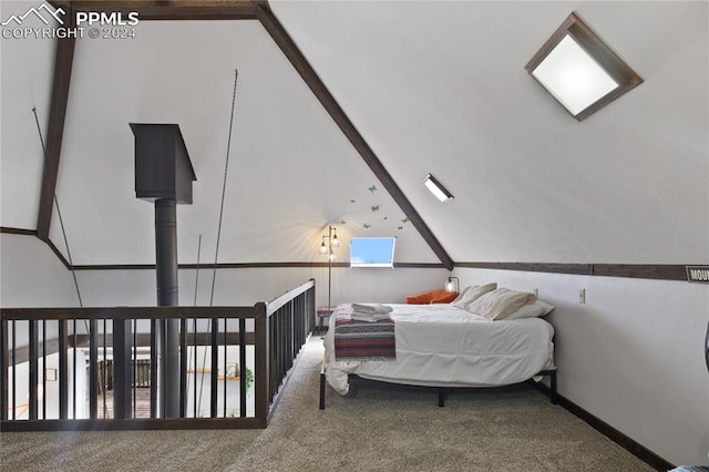 carpeted bedroom featuring beam ceiling and high vaulted ceiling