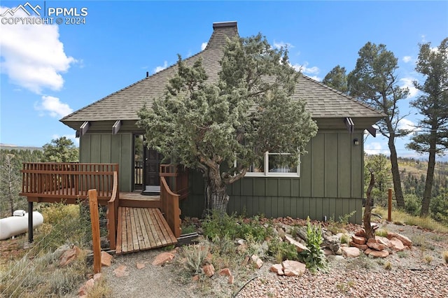 rear view of property with a wooden deck