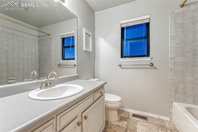 full bathroom with tiled shower / bath combo, vanity, and toilet