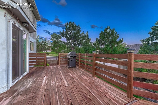 wooden terrace featuring area for grilling