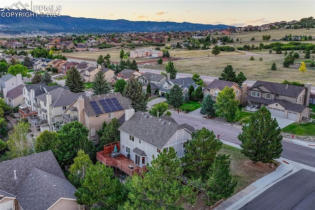 aerial view at dusk featuring a mountain view