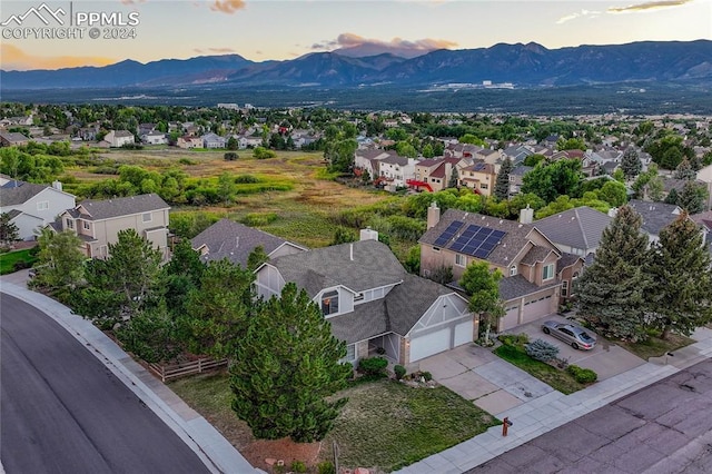 aerial view at dusk featuring a mountain view