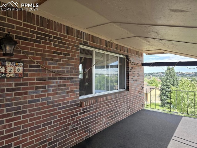 view of patio featuring a balcony