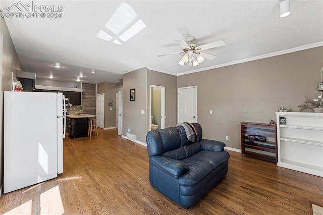 living room featuring ornamental molding, ceiling fan, and hardwood / wood-style flooring