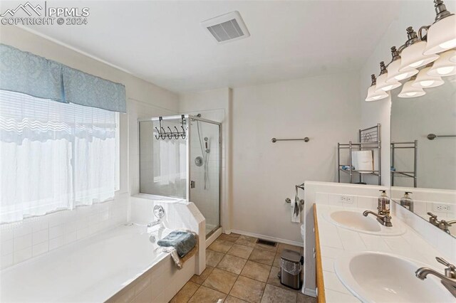 bathroom with independent shower and bath, vanity, and tile patterned floors