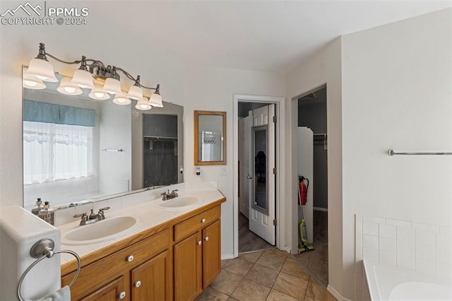 bathroom with vanity, a tub to relax in, and tile patterned floors