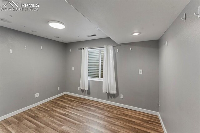 spare room featuring hardwood / wood-style floors