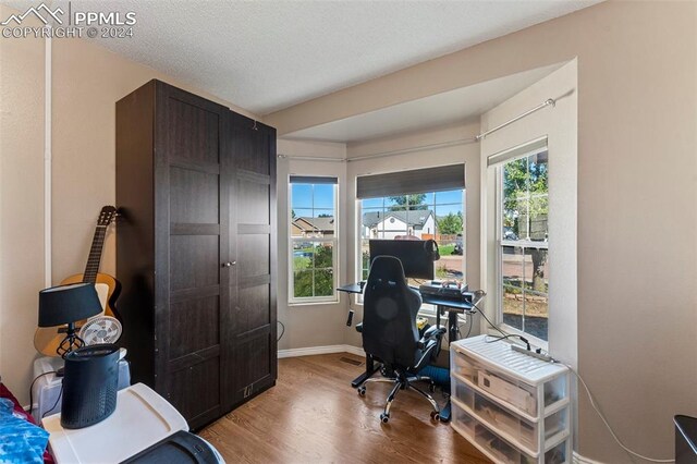 office space with a textured ceiling and hardwood / wood-style floors