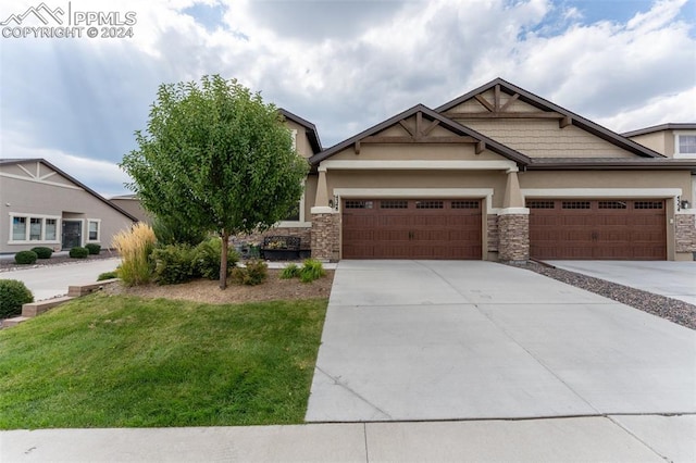 view of front of house with a garage and a front lawn