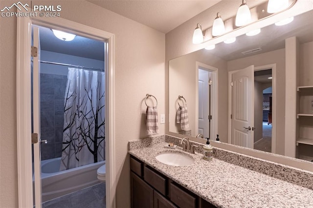 full bathroom with vanity, toilet, tile patterned floors, and shower / bath combo