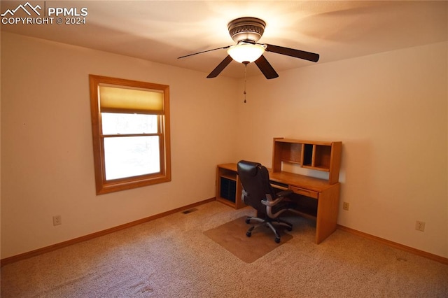 unfurnished office with carpet flooring and ceiling fan