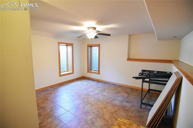 interior space with ceiling fan