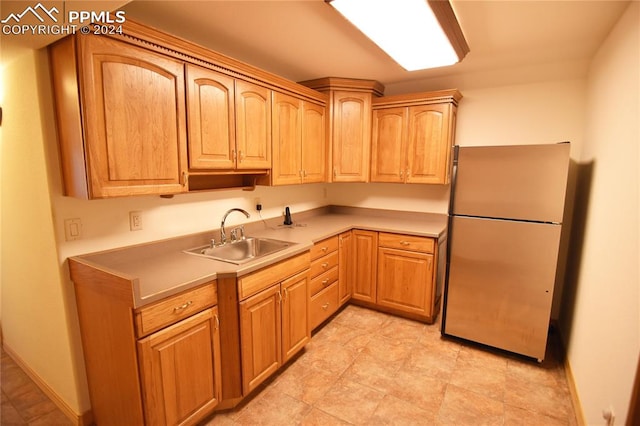 kitchen with sink and stainless steel fridge