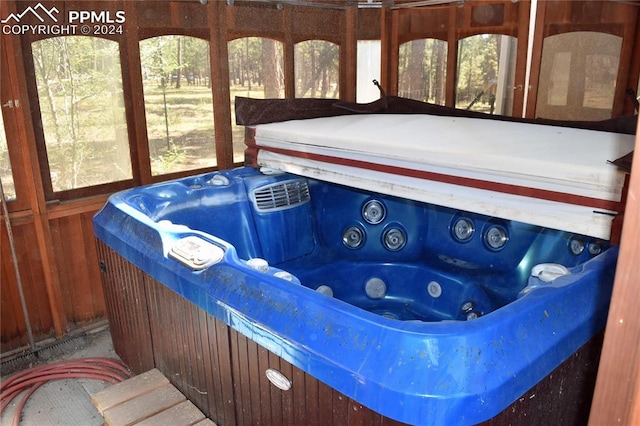 sunroom with a hot tub