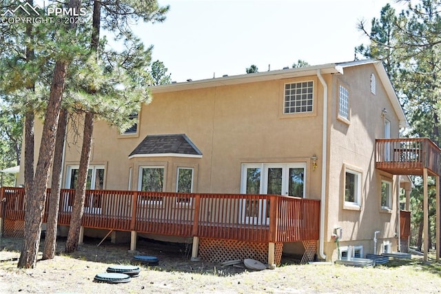 rear view of house featuring a wooden deck