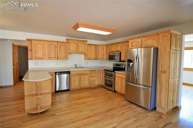 kitchen featuring light hardwood / wood-style flooring, light brown cabinetry, sink, and appliances with stainless steel finishes