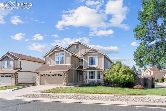 view of front of property with a front yard and a garage