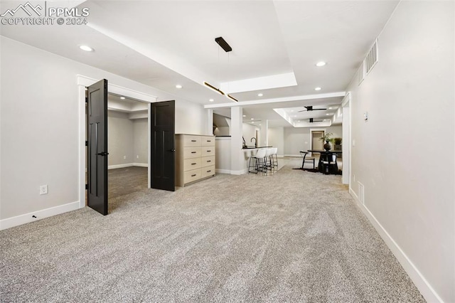 basement with carpet floors and ceiling fan