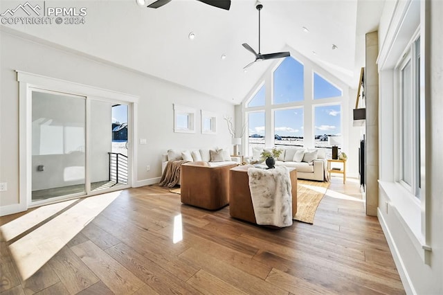 living room featuring ceiling fan, light hardwood / wood-style flooring, and high vaulted ceiling