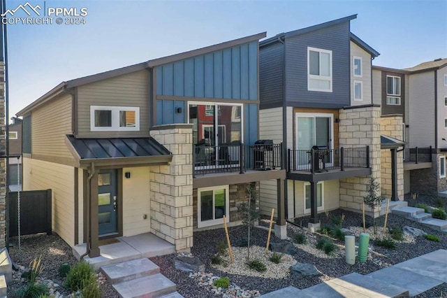 view of front of house featuring a balcony