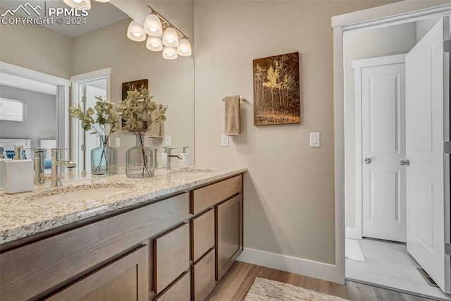 bathroom with vanity and hardwood / wood-style flooring