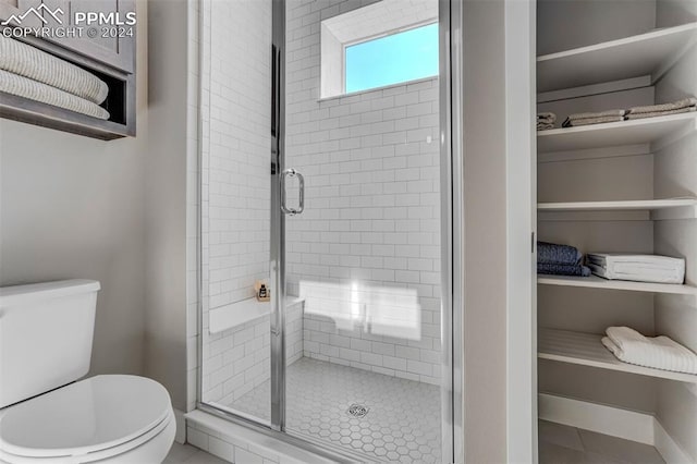 bathroom with toilet and walk in shower