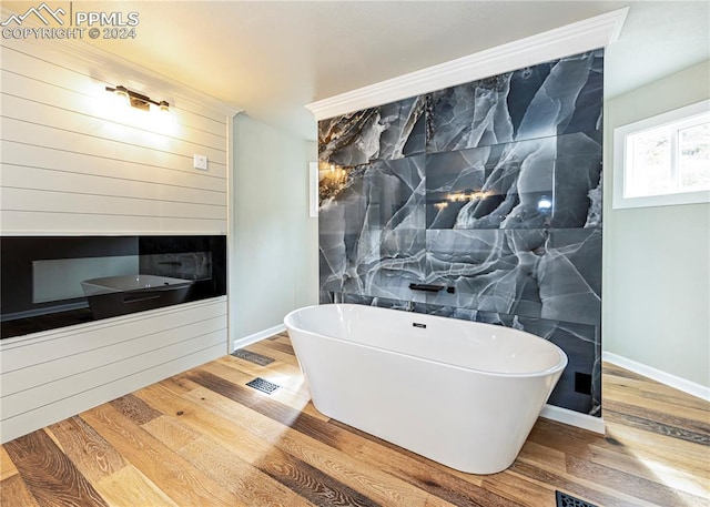 bathroom featuring a bath and wood-type flooring