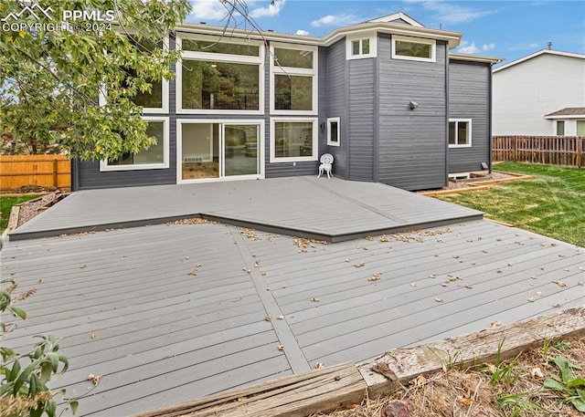 wooden deck with a lawn