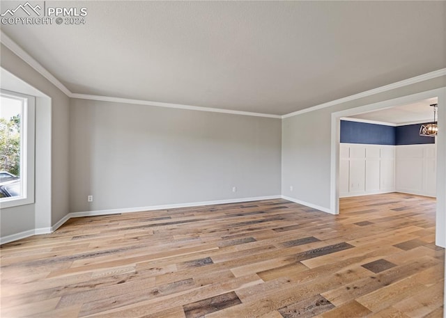 unfurnished room with crown molding and wood-type flooring