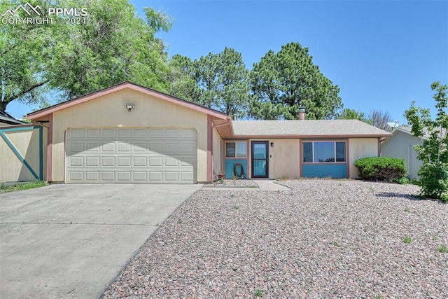 ranch-style home featuring a garage