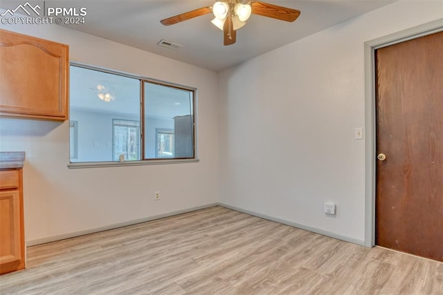 spare room featuring light hardwood / wood-style floors and ceiling fan