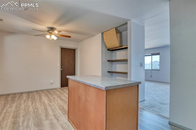 kitchen featuring ceiling fan and light hardwood / wood-style floors