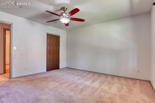 carpeted empty room with ceiling fan