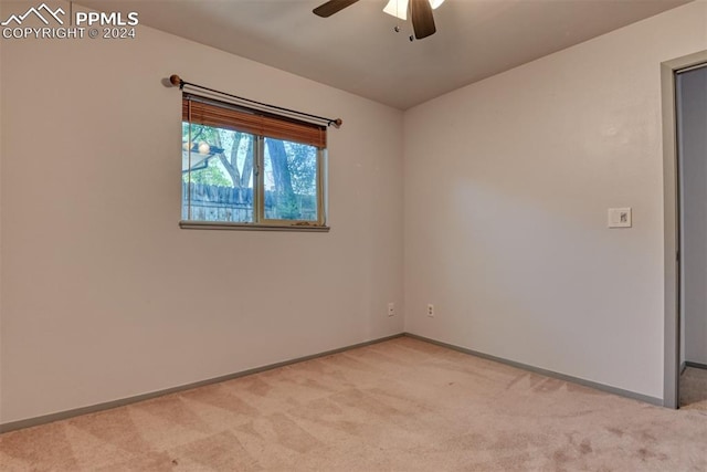 carpeted empty room featuring ceiling fan