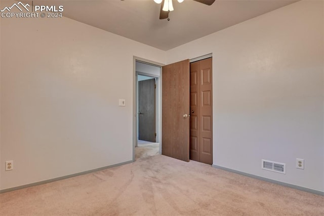 spare room with light carpet and ceiling fan