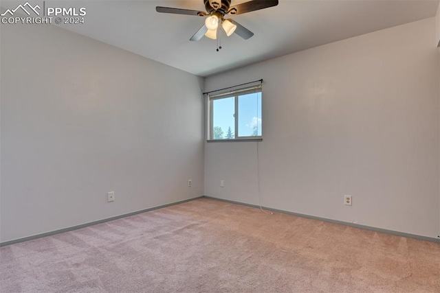 empty room with ceiling fan and light colored carpet