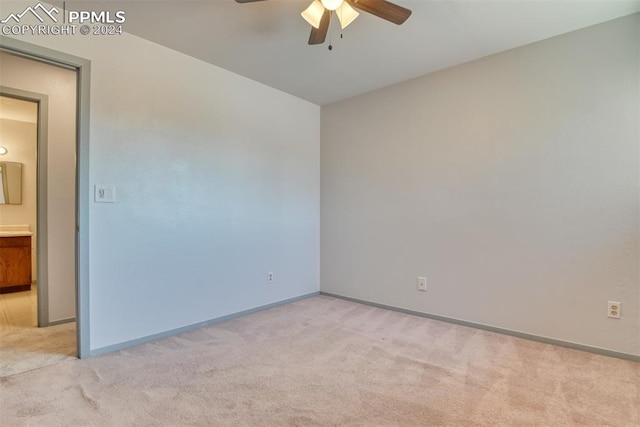 unfurnished room with ceiling fan and light colored carpet