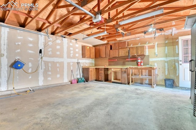 garage featuring a workshop area and a garage door opener